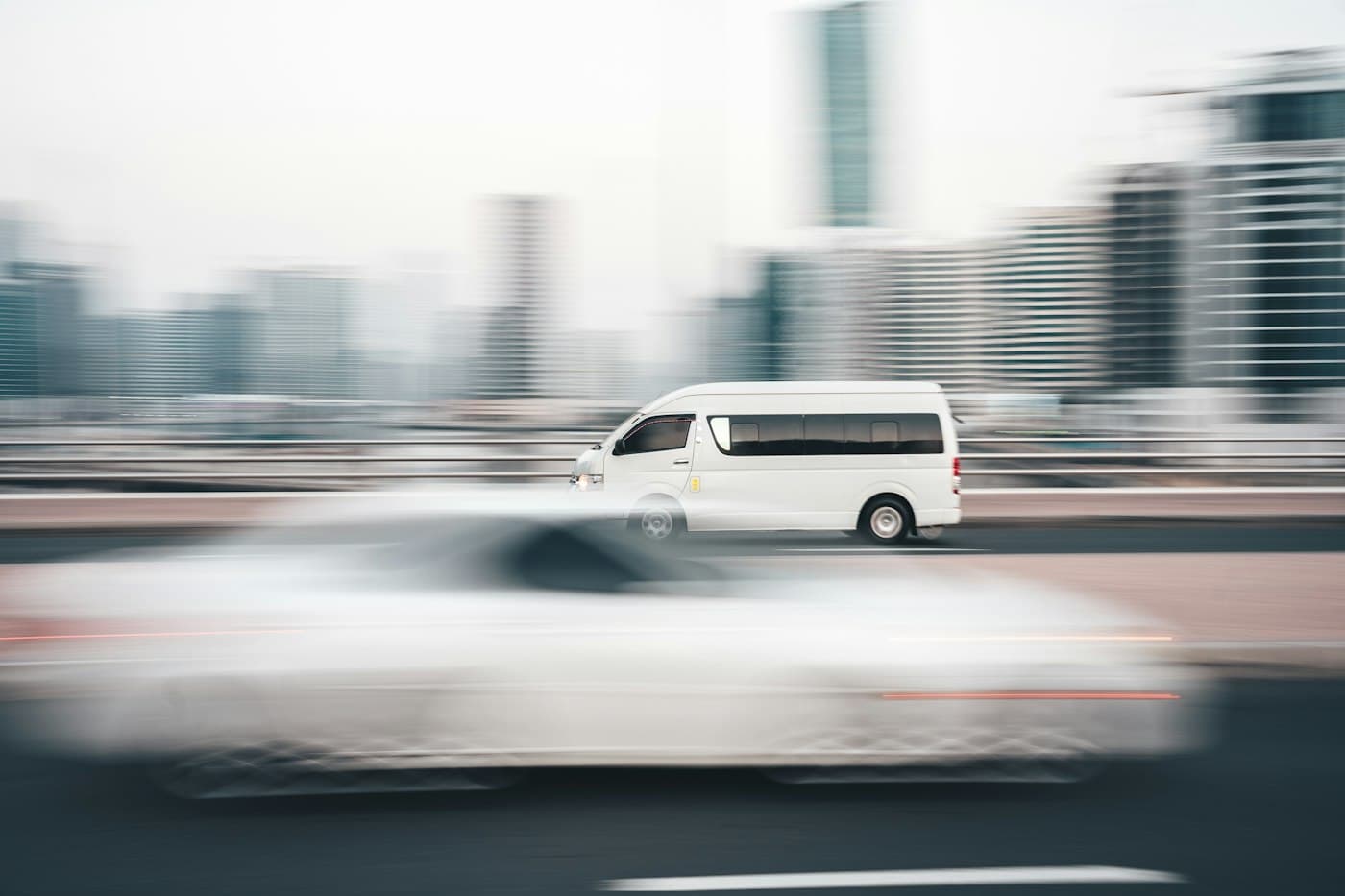 A white van driving along a city road
